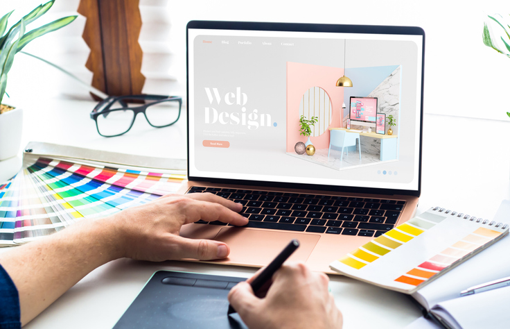 Designer with color palettes and laptop